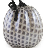Decorative pumpkin with black and white checkered pattern on a white background