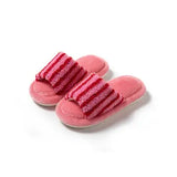 Pair of pink slippers with red striped top on a white background
