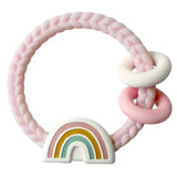 Pink baby teething ring with a rainbow design on a white background