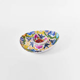 A shallow oval ceramic bowl with a colorful hand-painted floral and geometric pattern, shown on a clean white background.