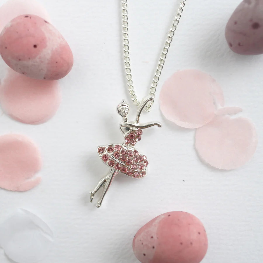 Necklace with a ballerina pendant on a white background with pink stones.