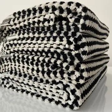 A stack of multicolored striped organic bath towels