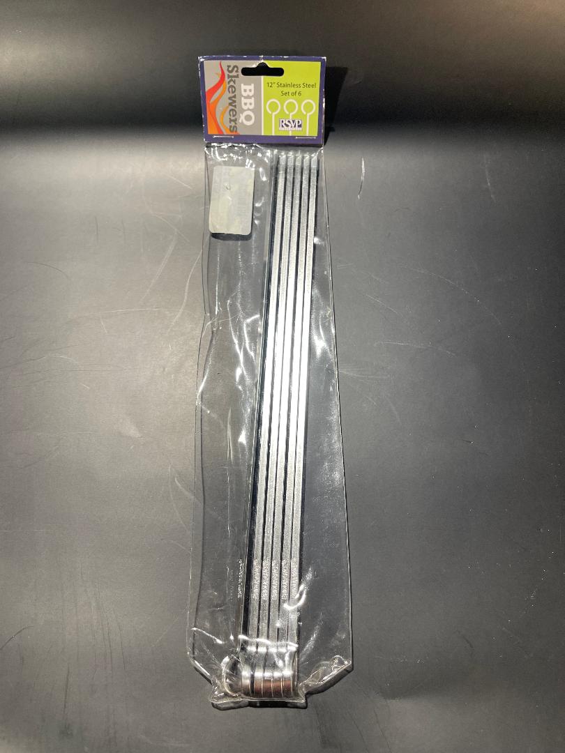 A set of six silver metal skewers packaged in clear plastic with a product label at the top.