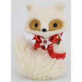 A plush toy resembling a white fox with a red and white decorative scarf.