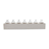 A set of clear glass vases placed on a beige wooden stand.