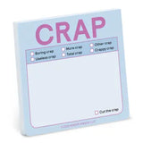 A square light blue notepad with pink text reading 'CRAP' at the top and several small checklist items below, shown on a plain white background.