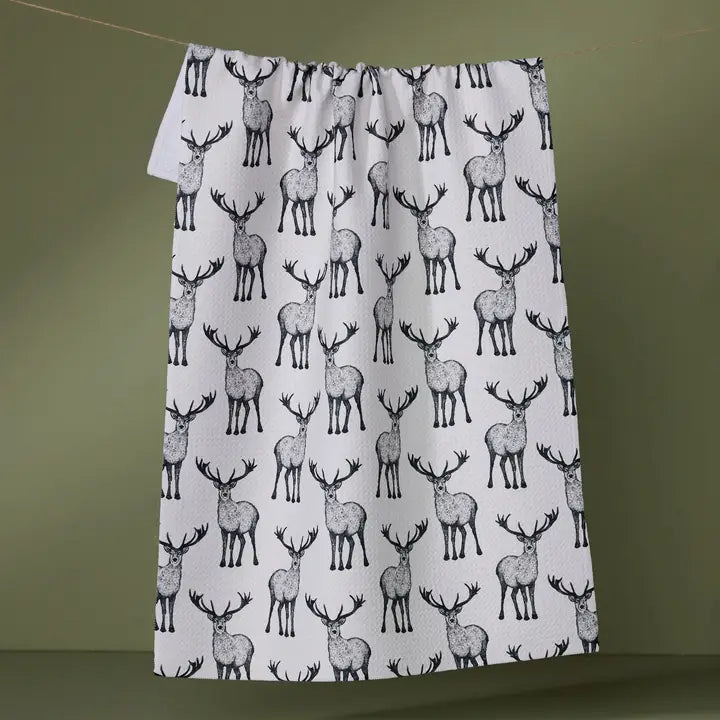 Patterned towel with deer design on a green background