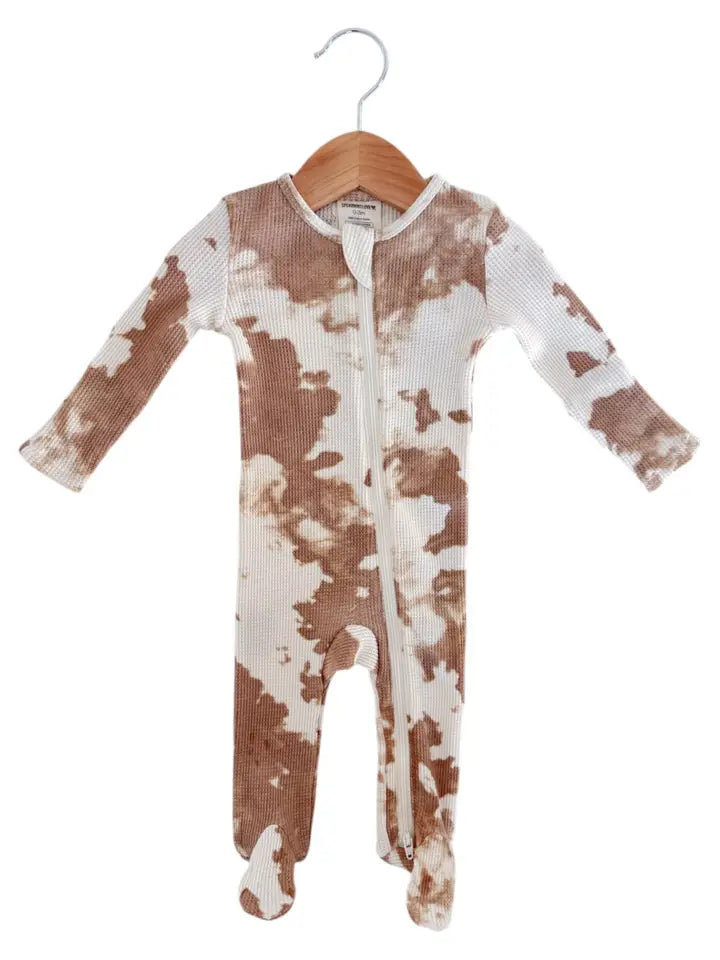 Baby onesie with brown and white tie-dye pattern on a hanger against a white background
