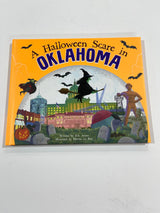 A children's book titled 'A Halloween Scare in Oklahoma' with an illustration of a witch, bats, and a castle on the cover.