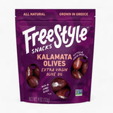 A 4 oz bag of Freestyle Snacks Kalamata Olives in Extra Virgin Olive Oil, featuring a deep purple packaging design with white and peach text, and clear windows showing the olives inside.