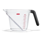 Clear measuring cup with black handle and red measurement markings on a white background