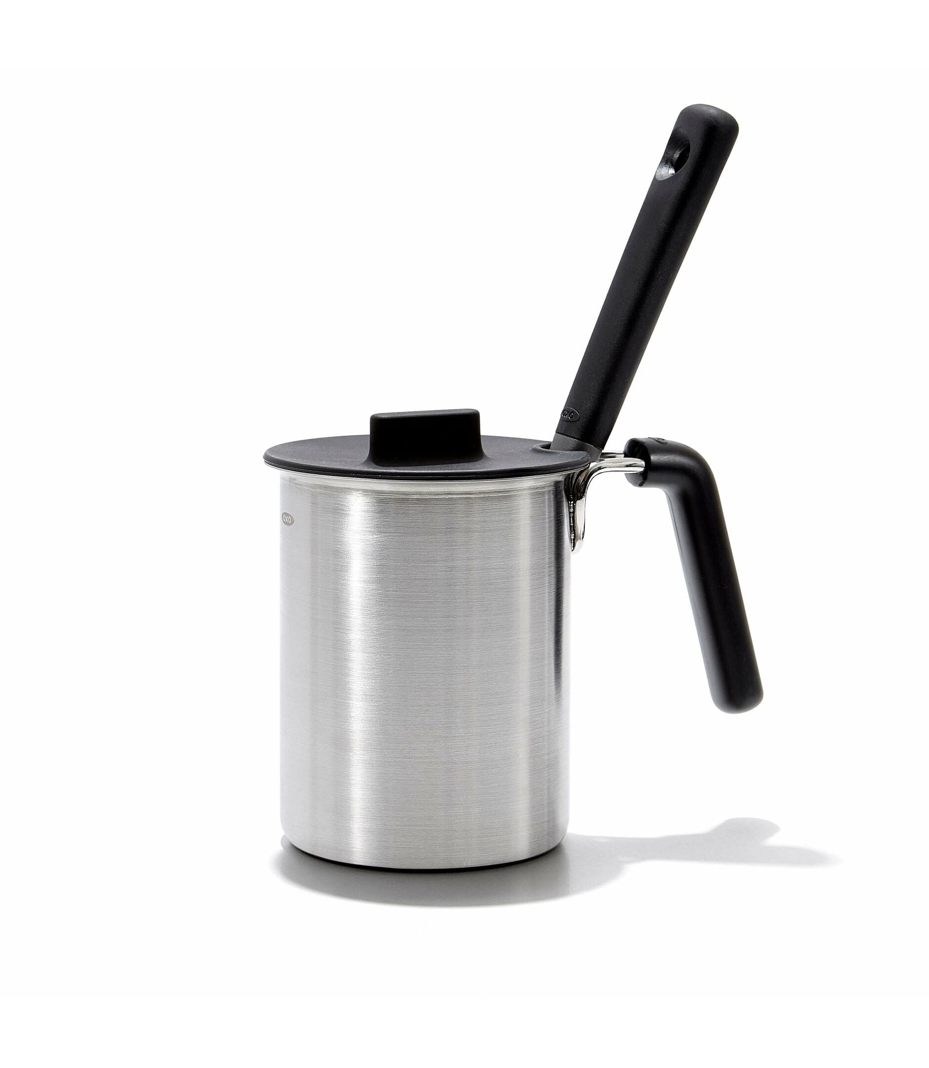 Stainless steel milk frother with black handle on a white background