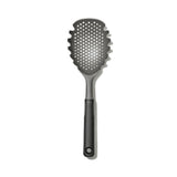 Spoon with holes to drain excess on a white back ground