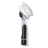 Cleaning brush with black handle and white bristle head on a white background