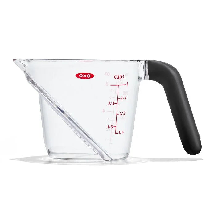 Clear measuring cup with black handle and OXO logo on a white background
