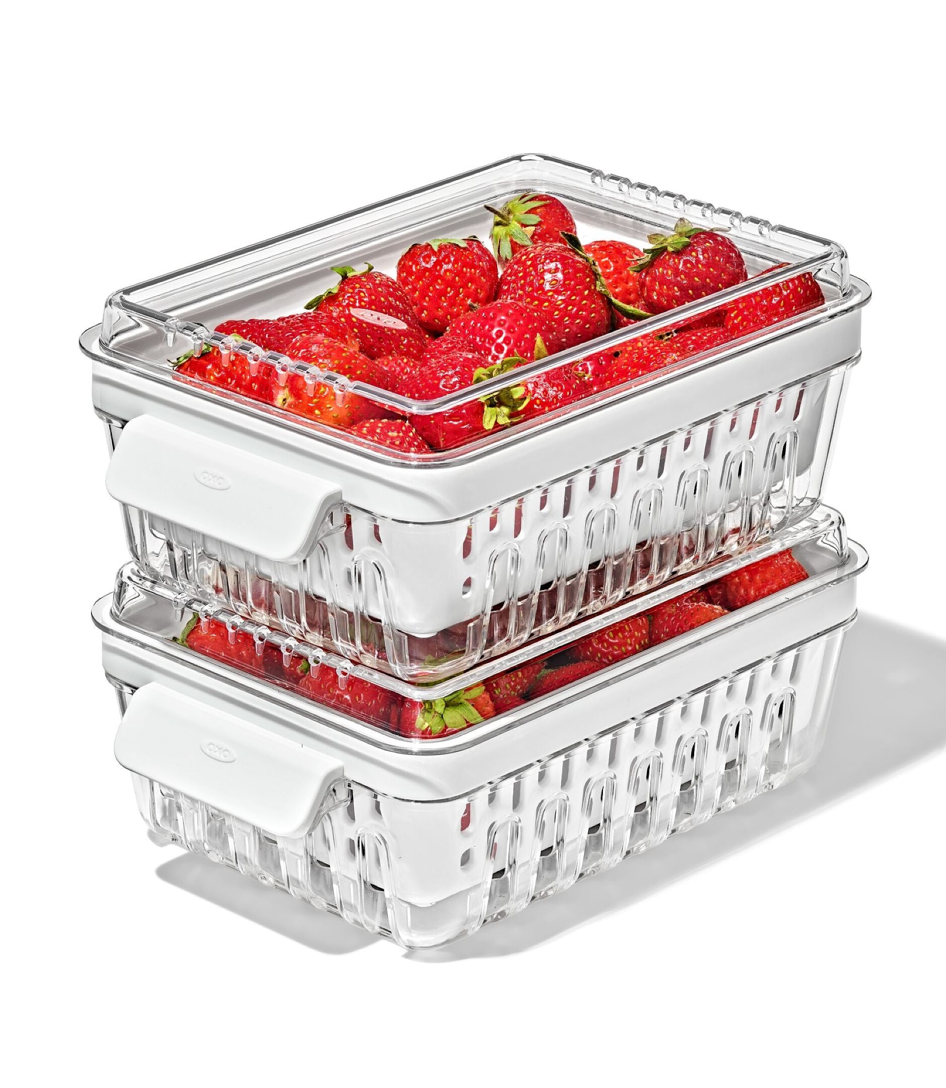Stackable plastic berry containers with strawberries on a white background