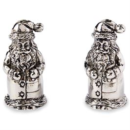 This image features a charming set of Santa salt and pepper shakers. Each shaker is intricately designed to resemble a jolly Santa Claus, complete with a festive hat adorned with a star and a flowing white beard.