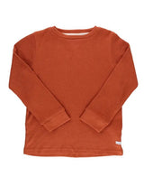 A burnt sienna colored waffle knit long-sleeved boy shirt.