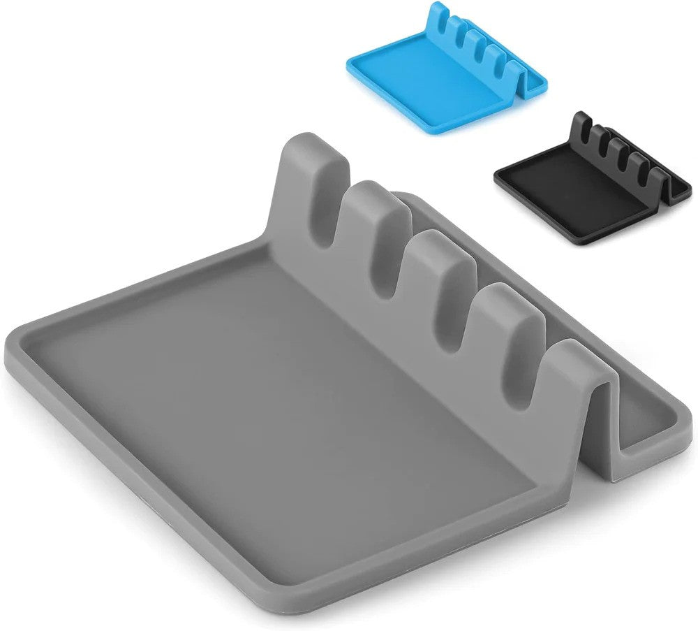 A gray silicone spoon rest with multiple compartments and a matching blue silicone mat.