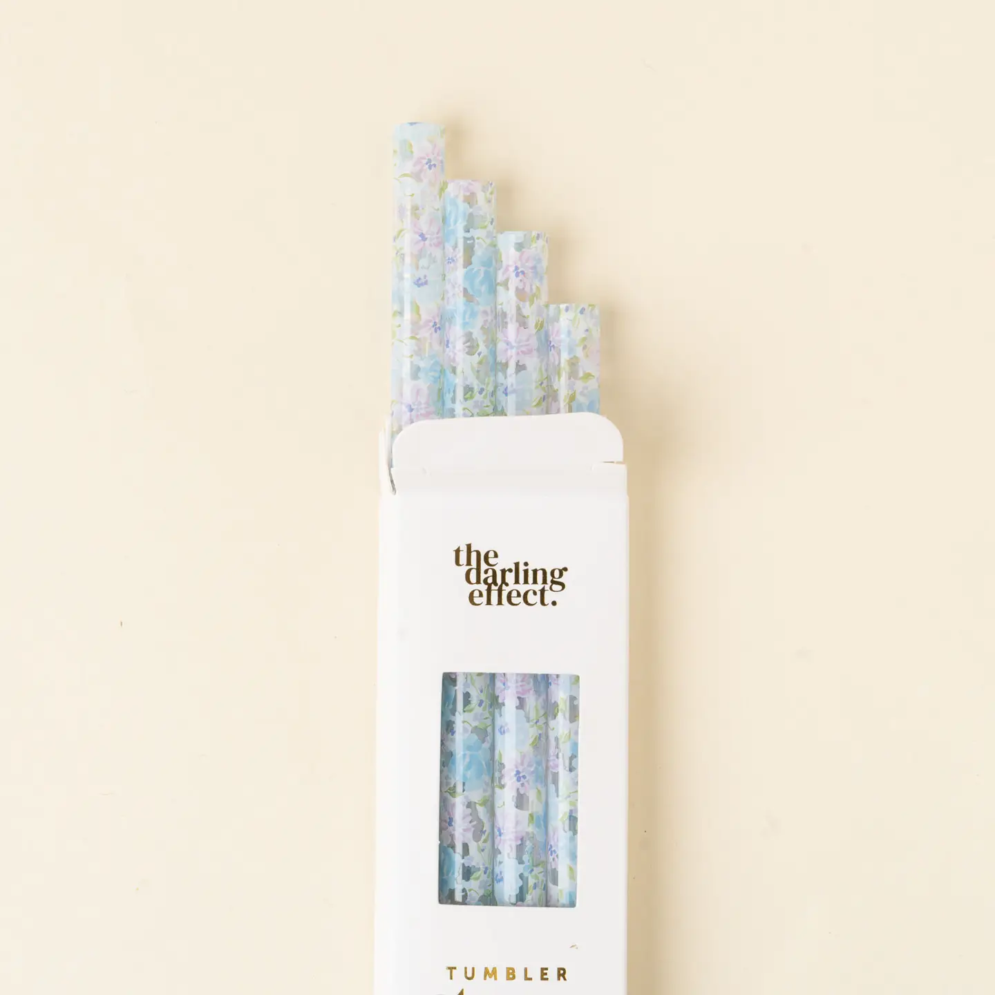 A pack of straws with a floral pattern, predominantly blue, displayed in a clear packaging with 'TUMBLER' printed on it.