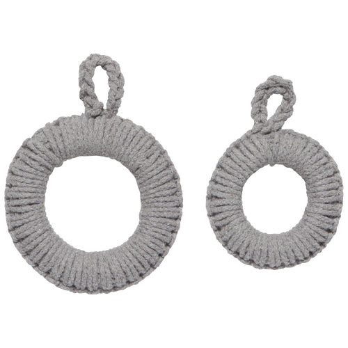 A set of two round, dove gray, solid pattern trivets made of a textile material with a loop for hanging.