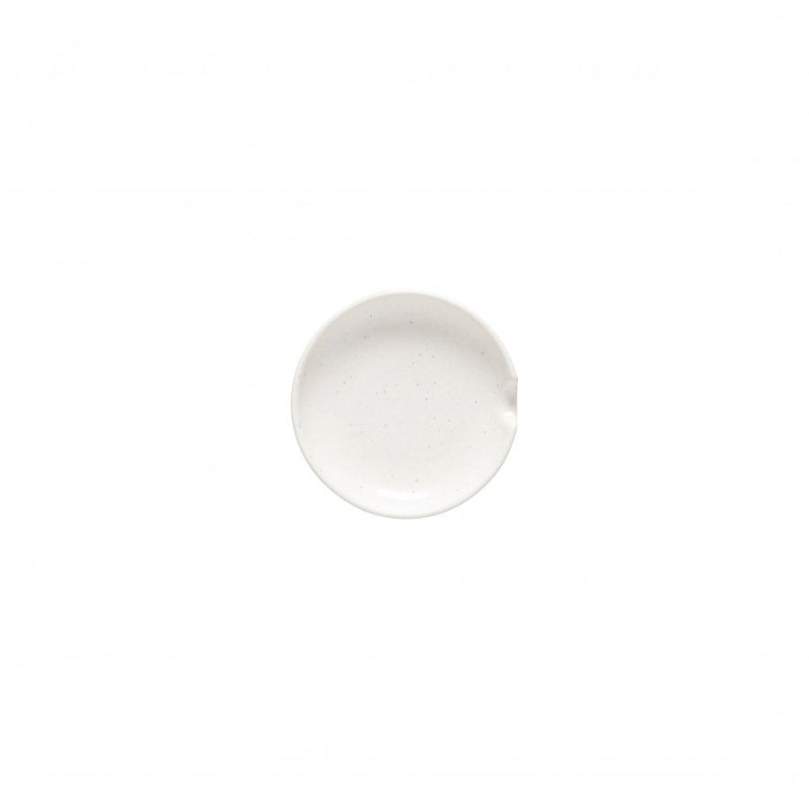 A white ceramic spoonrest with a textured edge on a plain background.