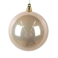 Beige Christmas ornament with gold cap on a white background