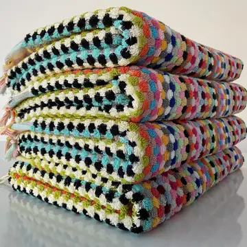 A stack of multicolored striped organic bath towels