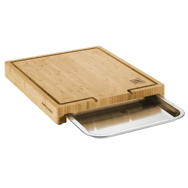 A wooden ZWILLING cutting board with a groove for draining, featuring a stainless steel blade.