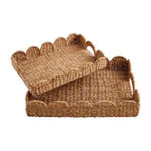 Two beige woven trays with scalloped edges, stacked inside each other.