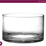 A clear glass straight-sided bowl on a white background.