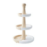 A two-tiered server made of wood and white plastic, with a cake on the top tier and a doughnut on the bottom tier.