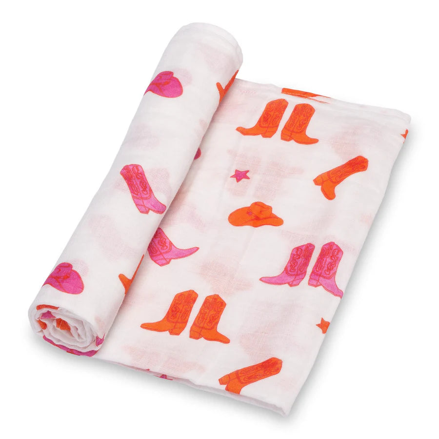 Two rolled-up burp cloths with pink and orange cowboy boot patterns on a white background.
