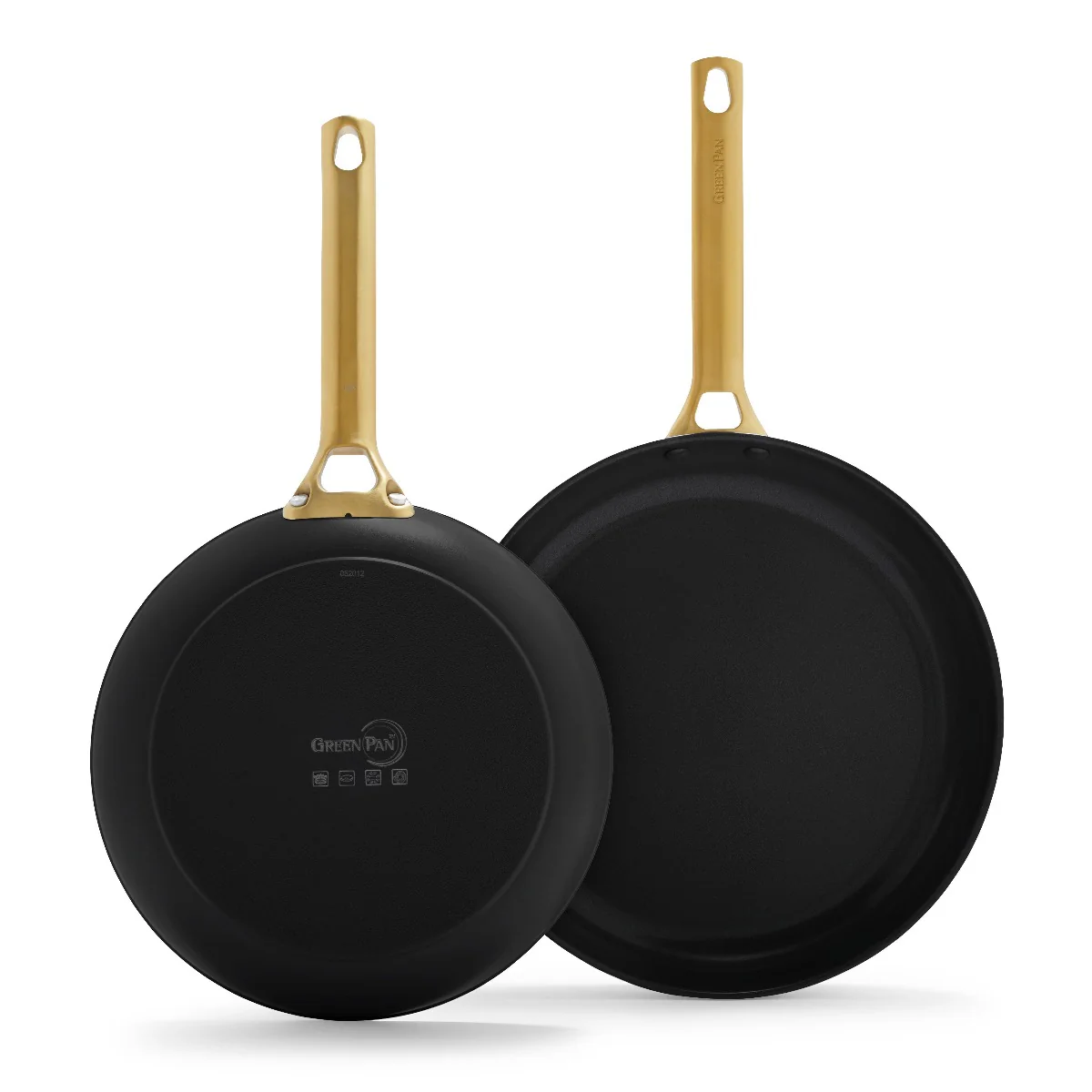 Two black ceramic nonstick frying pans with gold handles, one larger than the other, displayed back to back.