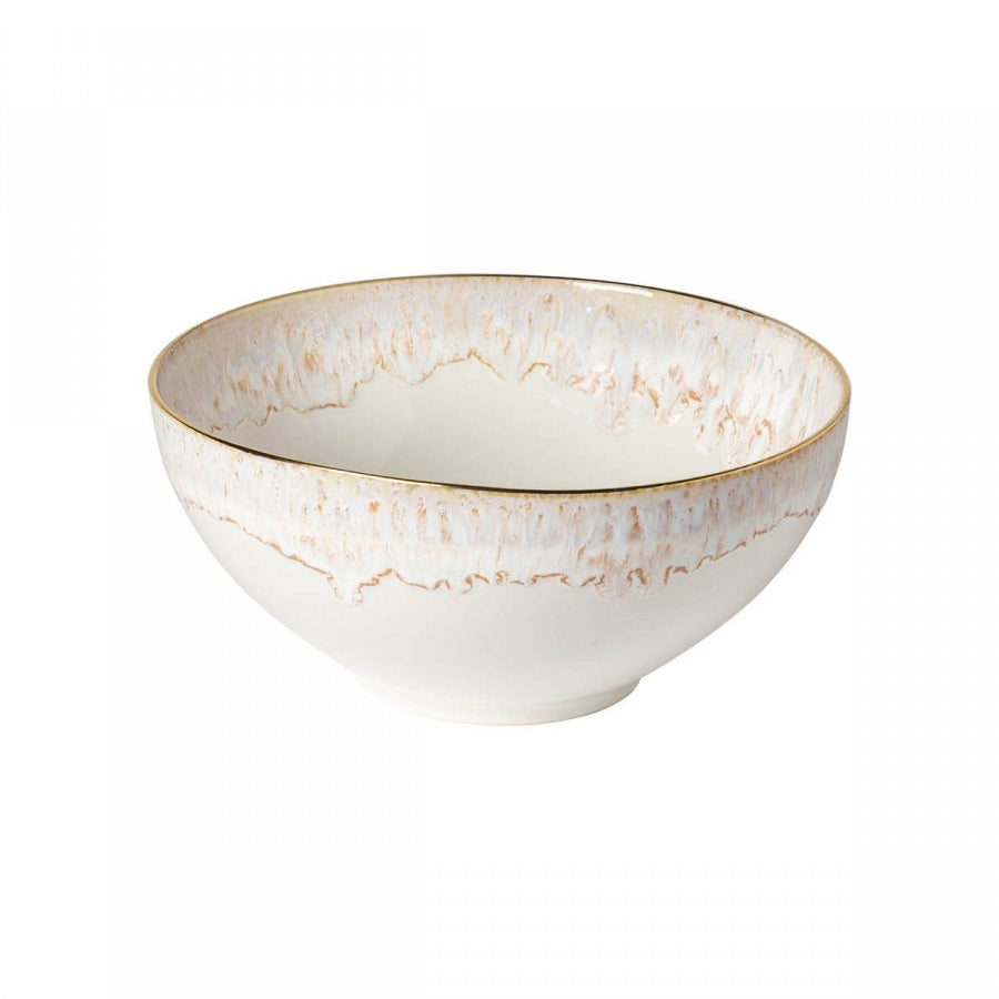 A white ceramic serving bowl with a geometric pattern and gold accents on the rim.