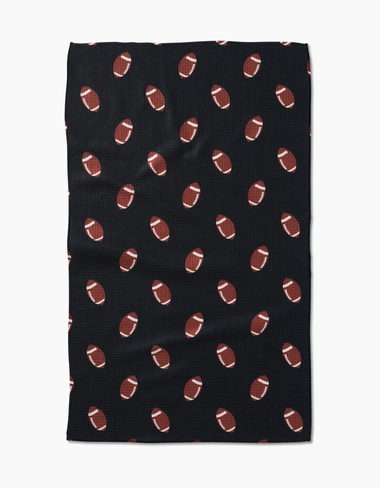 A black kitchen towel with a pattern of footballs in a repeating design.