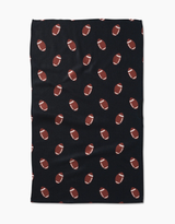 A black kitchen towel with a pattern of footballs in a repeating design.
