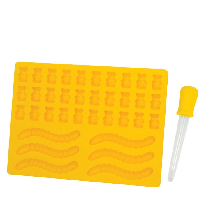 A yellow gelatin mold with cavities shaped like bears and worms, accompanied by a yellow dropper.