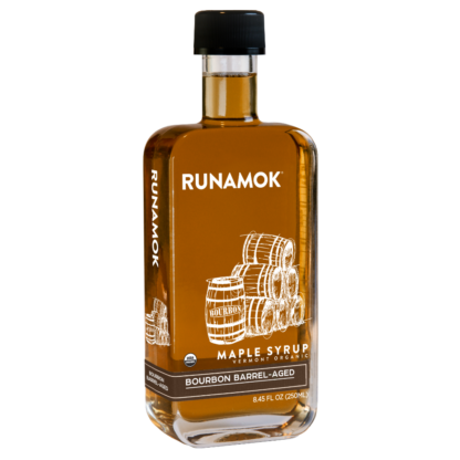 A bottle of Runamok Maple Syrup with a label indicating it is bourbon barrel-aged.