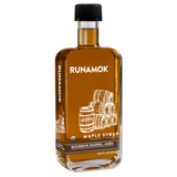 A bottle of Runamok Maple Syrup with a label indicating it is bourbon barrel-aged.