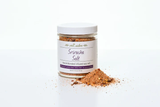 A clear jar filled with red-brown infused salt, with a white lid and a label that reads 'Salt Sister - Standardized Herb Salt - Infused Herbs'.