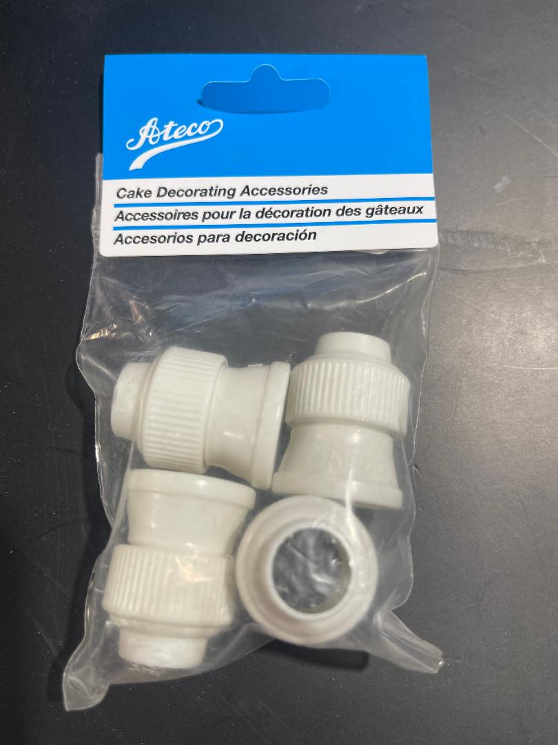 A pack of four white couplers for cake decorating, branded by Tefco, sealed in a plastic packaging with a blue and red label.