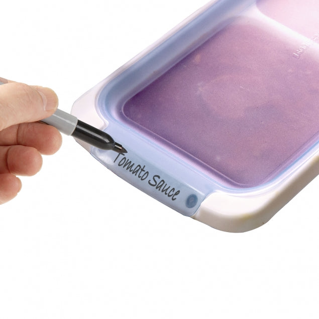 A hand holding a 2 Cup Freezer Portion Pod with a purple lid, labeled 'Tomato Sauce'.