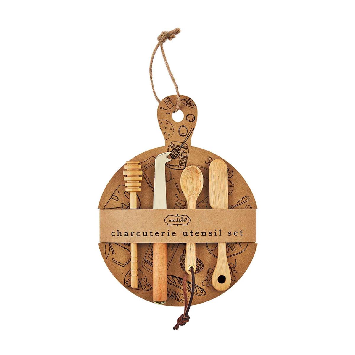 A charcuterie utensil set hanging on a cardboard ring, featuring various wooden spoons, forks, and tongs, with a label that reads 'CHARCUTERIE UTENSIL SET'.