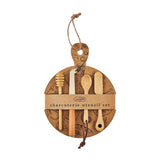 A charcuterie utensil set hanging on a cardboard ring, featuring various wooden spoons, forks, and tongs, with a label that reads 'CHARCUTERIE UTENSIL SET'.