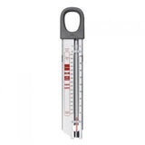 An OXO candy and deep fry thermometer with a clear dial and red markings, hanging from a loop at the top.