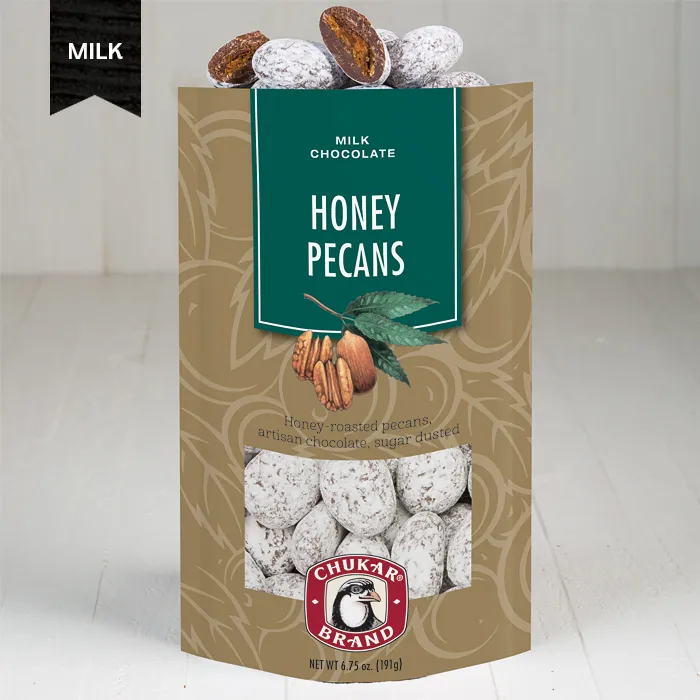 Packaging of Honey Pecans milk chocolate with visible chocolate coated pecans behind a clear window.