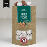 Packaging of Honey Pecans milk chocolate with visible chocolate coated pecans behind a clear window.