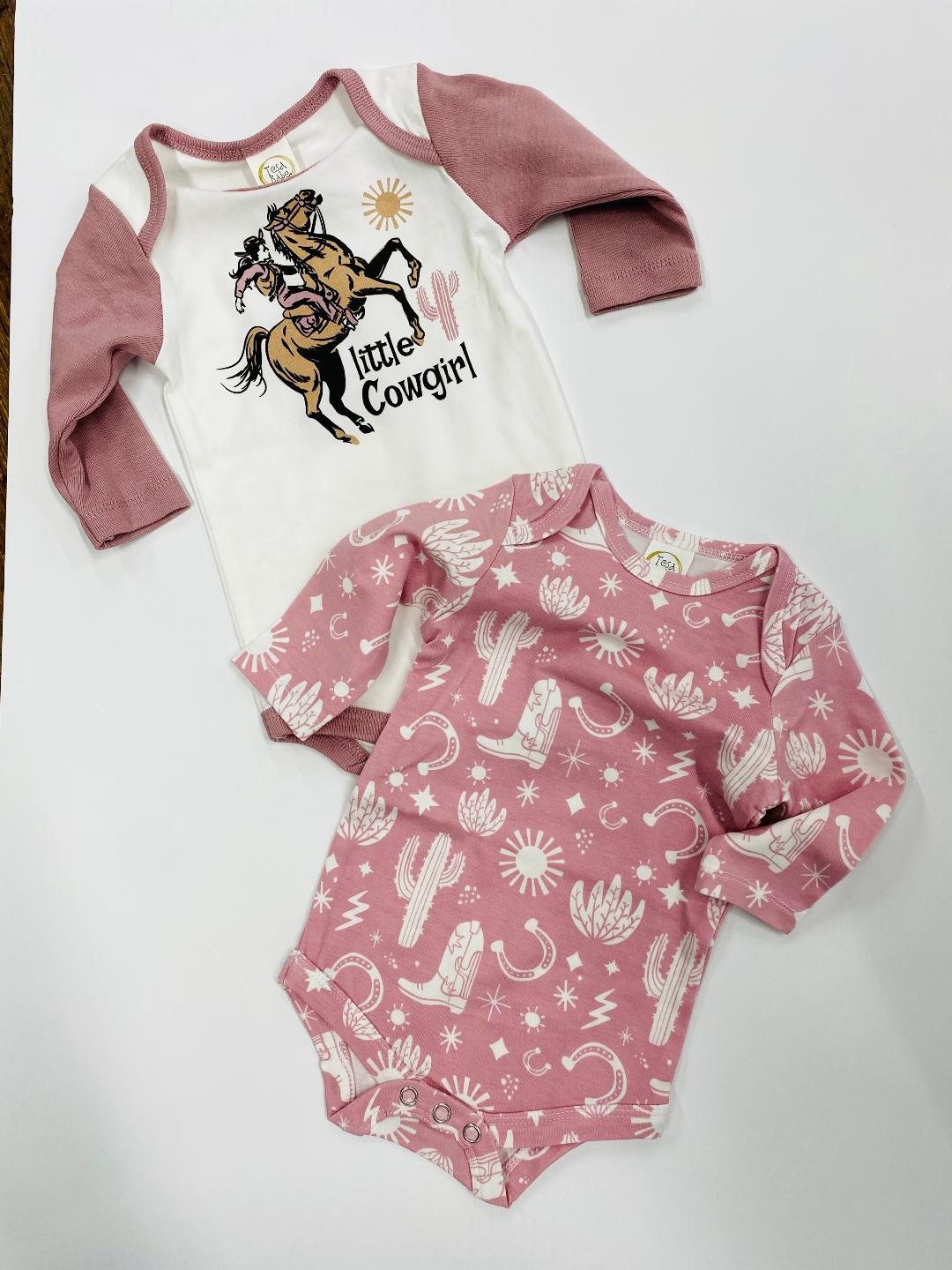 Two baby bodysuits, one with a dinosaur graphic and the text 'LITTLE FOCKARO', and the other with a pattern of cacti and stars.