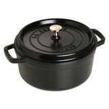 A black Staub Cocotte enameled Dutch oven with a lid and a handle on the side.